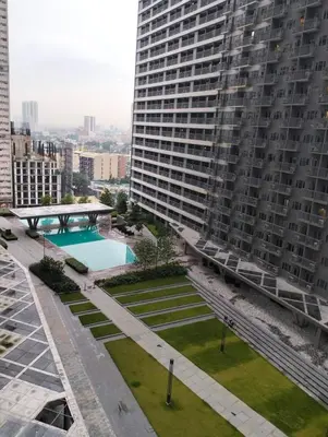 an aerial view of a large building with a swimming pool at SMDC Ortigas FAME in Manila