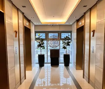 a hallway with three potted plants in a building at Heart of Ortigas in Manila