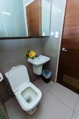 a bathroom with a toilet and a sink at 2 Bedroom Penthouse Air condo Makati Gym Swim Park 300 Mbps in Manila