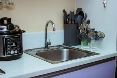 a kitchen counter with a sink and a microwave at 2 BR Air condo Makati Penthouse SwimGym 300Netflix 5249 in Manila
