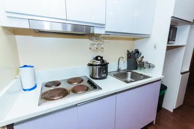 a kitchen with a stove with two donuts on it at 2 BR Air condo Makati Penthouse SwimGym 300Netflix 5249 in Manila