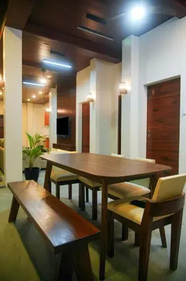 a dining room with a table and benches and a tv at Cozy Private Resort with Pool, Hijas Villa Binangonan in Binangonan