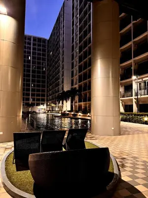 a fountain in the middle of a city at night at Lotus' Suite in Manila