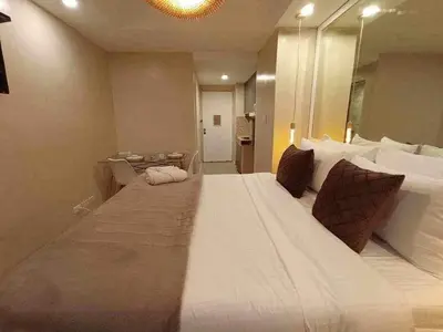a large white bed in a room with a large mirror at Shore Residence a31 shortwalk Mall of Asia in Manila