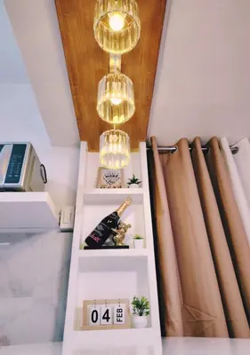 a room with a chandelier and a shelf at Aki's Place Binangonan in Binangonan