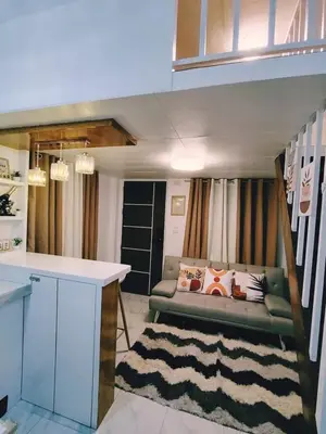 a living room with a couch and a table at Aki's Place Binangonan in Binangonan