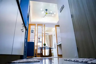 a hallway with a clock on the ceiling of a room at Seventh Ave in Manila