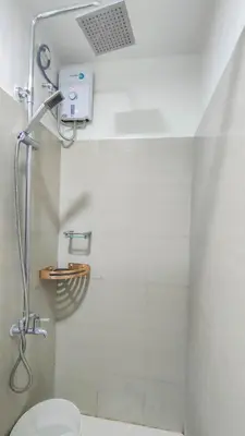 a bathroom with a shower with a toilet at Stylish Condo at Shore 2 Residences near MOA & Airport in Manila