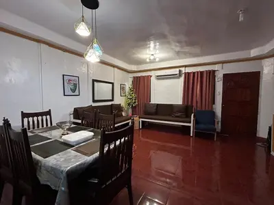 a living room with a table and a couch at Home in Imus Kawit with free mini pool in Kawit