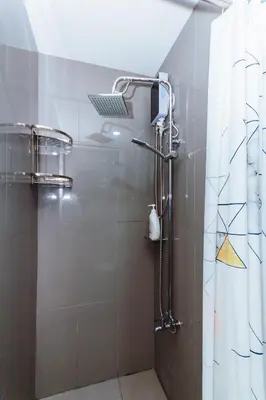 a bathroom with a shower with a laptop on the shower curtain at Witty Weekend retreat Quirk Cozy in Manila