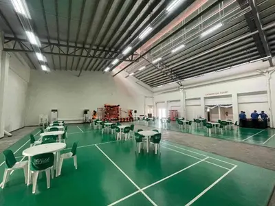 a tennis court with tables and chairs in a room at Elite King Comfort Stay Hotel Apartment - Near Manila Airport in Manila