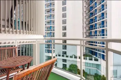 a balcony with a table and chairs and buildings at Azure Urban Resort Residences,BORACAY tower model unit in Manila