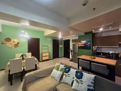 a living room and kitchen with a couch and a table at The Radiance of Manila Bay in Manila