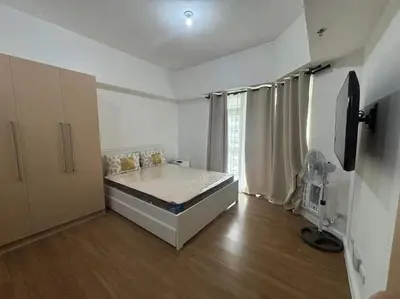 a bedroom with a bed in a room at City Front Studio in Manila