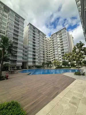 a large apartment building with a large swimming pool at City Front Studio in Manila