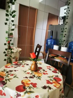 a table with a floral table cloth with a vase on it at Aldo shore 3 tower 2 mall of Asia in Manila