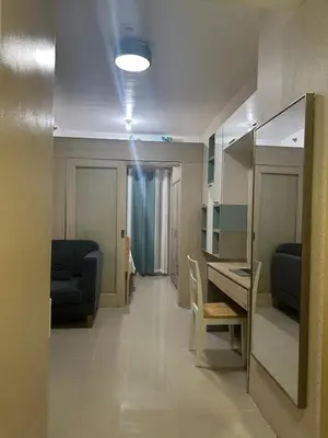 a living room with a table and chairs in a room at Modern & Cozy Two BR in Jazz Residences Makati City in Manila