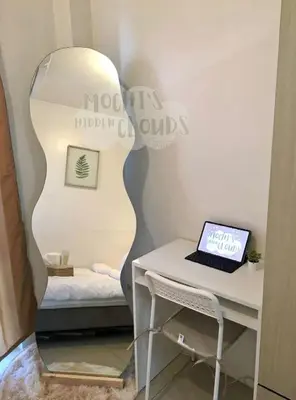 a room with a desk with a laptop and a mirror at Condotel with Balcony Near Airport and MOA with Games & Karaoke in Manila
