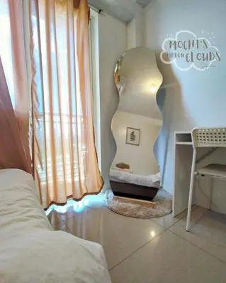 a bedroom with a bed with a light next to a window at Condotel with Balcony Near Airport and MOA with Games & Karaoke in Manila
