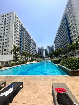 a swimming pool in front of tall buildings at 1bedroom with balcony at Sea Residences near MOA and SMX in Manila