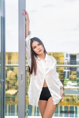 a young woman wearing a white shirt and black shorts at Spacious 2BR Apartment Hotel near City of Dreams, Airport, MOA, Okada, Ayala Malls, and Solaire Casino with free 5 pool access in Manila