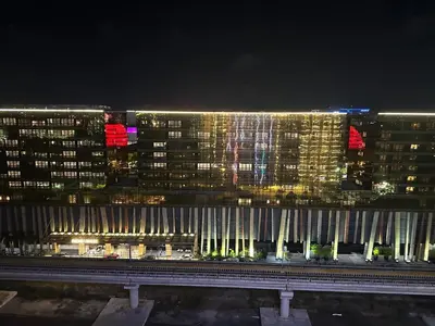 a night view of a city with tall buildings at Spacious 2BR Apartment Hotel near City of Dreams, Airport, MOA, Okada, Ayala Malls, and Solaire Casino with free 5 pool access in Manila