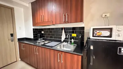 a kitchen with a sink and a microwave at GreySky Studio in Manila