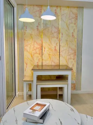 a room with a table with two lights on it at Azure Parañaque, 1BR Bahamas 15th floor in Manila