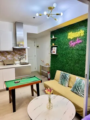 a living room with a couch and a table at Azure Parañaque, 1BR Bahamas 15th floor in Manila