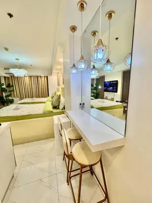 a dining room with a white table and two chairs at Azure Parañaque, 1BR Bahamas 19th floor in Manila