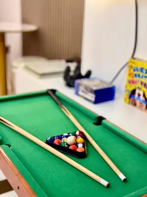 a pool table with cue sticks on top of it at Azure Parañaque, 1BR Bahamas 19th floor in Manila