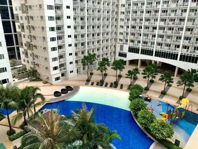 an overhead view of a swimming pool in front of buildings at Wowstaycation in Manila