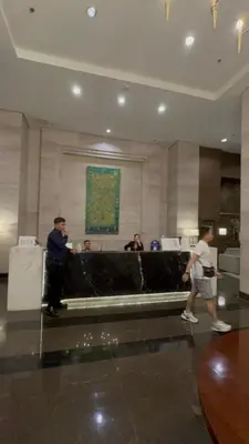 a group of people standing in a lobby at Radiance manila bay in Manila