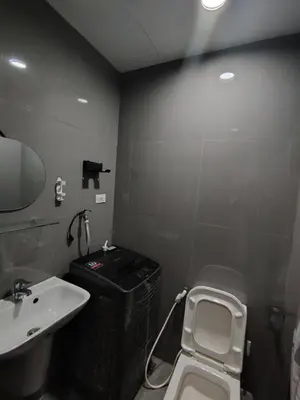a bathroom with a sink and a toilet at 1 Bedroom Cozy and Relaxing Place in Manila