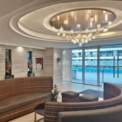 a large lobby with a chandelier in a building at 1 Bedroom unit in Fame Residence in Manila