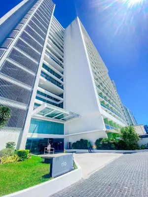 a large white building with two tall buildings at Azure Urban Resort Staycation 2 bedrooms beach view, 9th floor in Manila