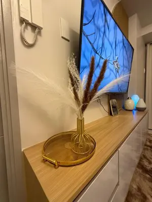 a vase with feathers in it sitting on a table at Glamorous SMDC Shore 3, 5 Star Rate BnB-Wifi-Netflix in Manila