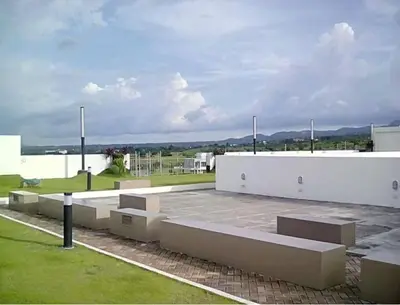 a parking lot with benches in front of a building at Cozy Suite with Private Patio near Nuvali in Silang