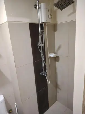 a shower in a bathroom with a toilet at Affordable Breeze Residence unit 2118 in Manila