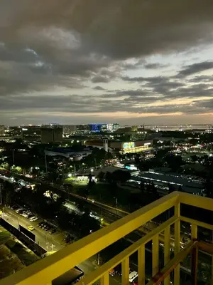 a view of a city at night with traffic at Coasis at SMDC Coast Residences in Manila