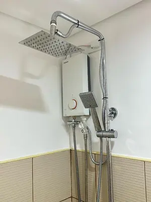 a shower in the corner of a bathroom at Micasa at Green 2 Residences in Dasmariñas