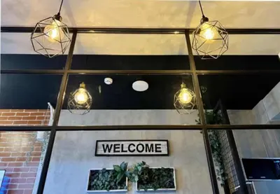 a welcome sign in the window of a store at Executive Suite 710A at S Residence by GK Condotel in Manila