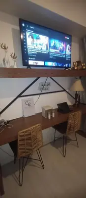 a desk with a television on top of it at Casa Crisav Staycation place at AZURE in Manila