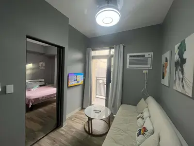 a living room with a couch and a table at Gentry Manor 2-Bed Near MOA&NAIA Okada Seaviw TV Netflix 17U in Manila