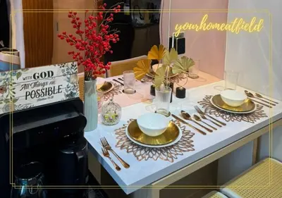 a table with plates and silverware on a table at Your HOME At Field Residences in Manila
