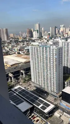 an aerial view of a city with buildings and solar panels at Crisean Highrise Condo - 100 West makati in Manila