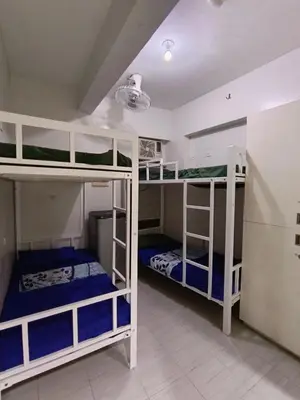 a room with three bunk beds in a room at City Space in Manila
