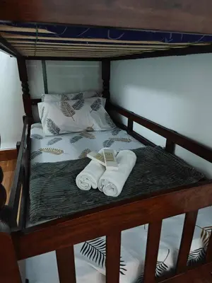 a bunk bed with two folded towels on it at Serenity Escapes by Aj in Manila
