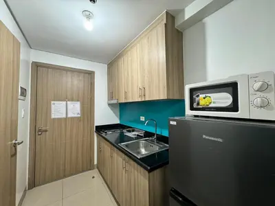 a small kitchen with a sink and a microwave at 726 Shore 2 Residences near SM MOA & IKEA by Prime Stay in Manila