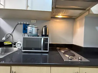 a microwave sitting on top of a kitchen counter at Sea Residences Briella's Staycation in Manila